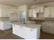 New kitchen featuring white cabinets, backsplash, and an island with a sink at 997 Oak Hollow St., Longs, SC 29568