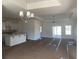 Open-concept living area with abundant natural light, a view of the kitchen, and a sliding glass door at 997 Oak Hollow St., Longs, SC 29568