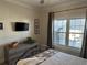 Bright bedroom with a window view, dresser, TV, and comfortable bedding at 1025 Ray Costin Way # 1008, Murrells Inlet, SC 29576