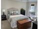 Comfortable bedroom with a beautifully decorated bed, accent chair, and plenty of natural light at 1025 Ray Costin Way # 1008, Murrells Inlet, SC 29576
