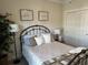 Cozy bedroom featuring a decorative wrought iron bed frame and a large tree at 1025 Ray Costin Way # 1008, Murrells Inlet, SC 29576