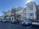 Three story building with balconies and yellow siding and brick accents with parking at 1025 Ray Costin Way # 1008, Murrells Inlet, SC 29576