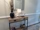 Stylish entryway with a decorative vase, lamp, mirror, and a console table at 1025 Ray Costin Way # 1008, Murrells Inlet, SC 29576