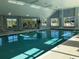 Bright indoor pool and hot tub offer a relaxing amenity, surrounded by large windows at 1025 Ray Costin Way # 1008, Murrells Inlet, SC 29576