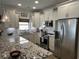 Bright kitchen with granite counters, stainless appliances and white cabinetry at 1025 Ray Costin Way # 1008, Murrells Inlet, SC 29576