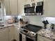 Modern kitchen featuring stainless steel appliances, granite countertops, and white cabinets at 1025 Ray Costin Way # 1008, Murrells Inlet, SC 29576