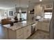 Open-concept kitchen boasts granite countertops, white cabinetry, and stainless steel appliances at 1025 Ray Costin Way # 1008, Murrells Inlet, SC 29576