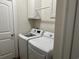 Practical laundry room features modern appliances and cabinet storage for efficient organization and convenience at 1025 Ray Costin Way # 1008, Murrells Inlet, SC 29576