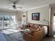 Bright living room with a leather sectional sofa, and a view to an outdoor patio at 1025 Ray Costin Way # 1008, Murrells Inlet, SC 29576