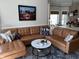 Inviting living room featuring a plush, brown leather sectional sofa and stylish decor at 1025 Ray Costin Way # 1008, Murrells Inlet, SC 29576