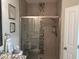 Modern tiled shower with glass doors and built-in shelving at 1025 Ray Costin Way # 1008, Murrells Inlet, SC 29576