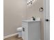 Half bathroom with white vanity, black faucet, and modern lighting fixtures at 1101 Possum Trot Rd. # C-303, North Myrtle Beach, SC 29582