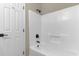 Bathroom featuring a white tub/shower combo with black fixtures and a white door at 1101 Possum Trot Rd. # C-303, North Myrtle Beach, SC 29582