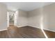 Empty bedroom with wood-look floors showcases a doorway to another room in the home at 1101 Possum Trot Rd. # C-303, North Myrtle Beach, SC 29582