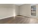Bright bedroom featuring wood-look floors and natural light streaming through a window at 1101 Possum Trot Rd. # C-303, North Myrtle Beach, SC 29582