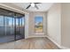 Bright bedroom featuring wood flooring and a sliding glass door to a screened porch at 1101 Possum Trot Rd. # C-303, North Myrtle Beach, SC 29582