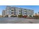 Three-story condo building with blue siding and neatly maintained landscaping at 1101 Possum Trot Rd. # C-303, North Myrtle Beach, SC 29582