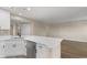 Open kitchen layout with white cabinets and a view into the living area at 1101 Possum Trot Rd. # C-303, North Myrtle Beach, SC 29582