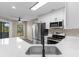 Bright kitchen featuring quartz countertops, stainless appliances, and white cabinetry at 1101 Possum Trot Rd. # C-303, North Myrtle Beach, SC 29582