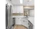 Modern kitchen with stainless steel appliances and stylish white cabinetry at 1101 Possum Trot Rd. # C-303, North Myrtle Beach, SC 29582