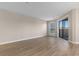 Bright living room featuring wood flooring and a sliding glass door to a screened porch at 1101 Possum Trot Rd. # C-303, North Myrtle Beach, SC 29582
