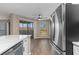 Kitchen and dining area with stainless appliances, quartz countertop and balcony access at 1101 Possum Trot Rd. # C-303, North Myrtle Beach, SC 29582