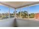 Screened porch showcasing golf course and pond views through large windows at 1101 Possum Trot Rd. # C-303, North Myrtle Beach, SC 29582