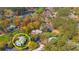 Aerial view of home surrounded by trees, nestled in a green landscape, adjacent to a golf course at 110-4 White Tail Way # 4, Pawleys Island, SC 29585