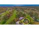 Aerial view of home nestled in lush greenery, adjacent to a golf course and the ocean at 110-4 White Tail Way # 4, Pawleys Island, SC 29585
