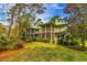 The backyard includes a lawn, mature trees, and a screened in porch at 110-4 White Tail Way # 4, Pawleys Island, SC 29585