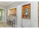 Unique bar featuring a pass-through window to the kitchen with seating and storage at 110-4 White Tail Way # 4, Pawleys Island, SC 29585