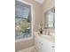 Bathroom with vanity and sink, a window view, and decorative accents on the countertop at 110-4 White Tail Way # 4, Pawleys Island, SC 29585