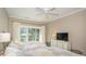 Bedroom with two beds, TV, ceiling fan, and sliding glass doors to a balcony at 110-4 White Tail Way # 4, Pawleys Island, SC 29585
