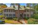 Two-story home with brick and siding exterior, landscaped front yard, and well manicured yard at 110-4 White Tail Way # 4, Pawleys Island, SC 29585