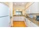 Well-appointed kitchen with white cabinets, granite countertops, and stainless steel appliances at 110-4 White Tail Way # 4, Pawleys Island, SC 29585