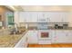 Bright kitchen featuring white cabinets, granite counters, and stainless steel appliances at 110-4 White Tail Way # 4, Pawleys Island, SC 29585