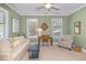 Comfortable living room with a sofa, desk, armchair, and natural light at 110-4 White Tail Way # 4, Pawleys Island, SC 29585