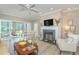 Cozy living room with fireplace, ceiling fan, and access to a screened porch at 110-4 White Tail Way # 4, Pawleys Island, SC 29585