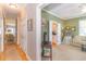 Open living room featuring a hallway, a TV on a stand, and a partial view of the kitchen at 110-4 White Tail Way # 4, Pawleys Island, SC 29585