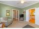 Cozy living room with a chair, a TV on a stand, and a partial view of the kitchen at 110-4 White Tail Way # 4, Pawleys Island, SC 29585