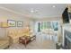 Bright living room featuring a fireplace, ceiling fan, and sliding glass doors to the outside patio at 110-4 White Tail Way # 4, Pawleys Island, SC 29585