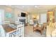 Open-concept living room with dining area, fireplace, and view into the kitchen at 110-4 White Tail Way # 4, Pawleys Island, SC 29585
