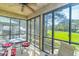 Relaxing screened porch with golf course views, ceiling fan, and comfortable seating at 110-4 White Tail Way # 4, Pawleys Island, SC 29585