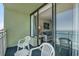 View from balcony into the room, showcasing the furniture inside and the beach outside at 1105 S Ocean Blvd. # 1224, Myrtle Beach, SC 29577