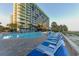 Relaxing outdoor pool deck with lounge chairs and palm trees at this resort community by the beach at 1105 S Ocean Blvd. # 1224, Myrtle Beach, SC 29577