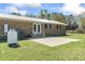 Brick exterior home with a concrete patio, natural gas tank and lush backyard with some shade at 1136 Knotty Branch Rd., Conway, SC 29527
