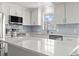 Bright kitchen with stainless steel appliances, gray backsplash, white cabinetry, and quartz countertops at 1136 Knotty Branch Rd., Conway, SC 29527