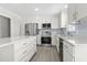 Bright kitchen with an island, stainless appliances, modern cabinetry, and light gray backsplash at 1136 Knotty Branch Rd., Conway, SC 29527