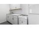 A well-lit kitchen features white cabinets, a modern sink, and a clean white stove and refrigerator at 1136 Knotty Branch Rd., Conway, SC 29527