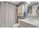 Well-lit bathroom featuring a vanity, mirror, toilet, and shower with a curtain at 1210 N Waccamaw Dr. # 408, Garden City Beach, SC 29576